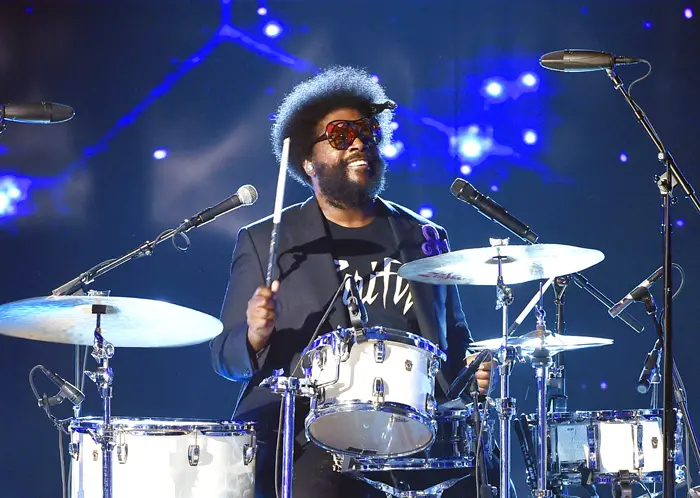 Questlove playing a beautiful white drum set live