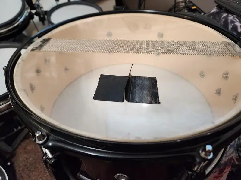 Sticking the gaffer tape to the bottom drumhead